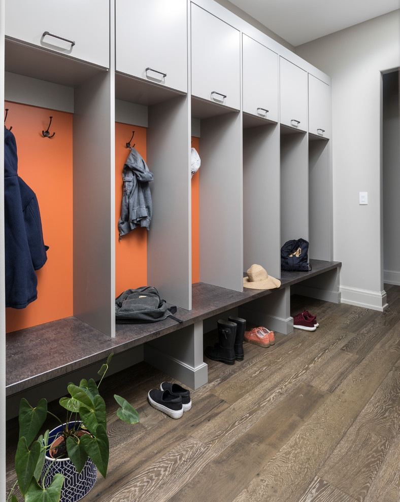 Design ideas for a contemporary mudroom in Detroit with grey walls and dark hardwood floors.