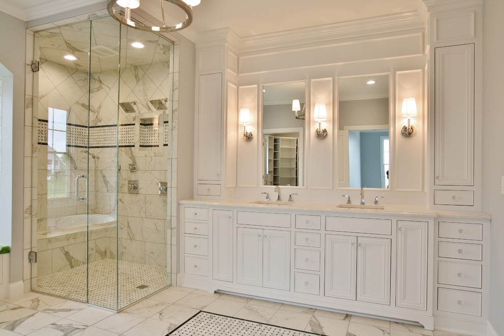 Large transitional master ceramic tile and white floor corner shower photo with flat-panel cabinets, white cabinets, quartz countertops, beige walls, an undermount sink and a hinged shower door