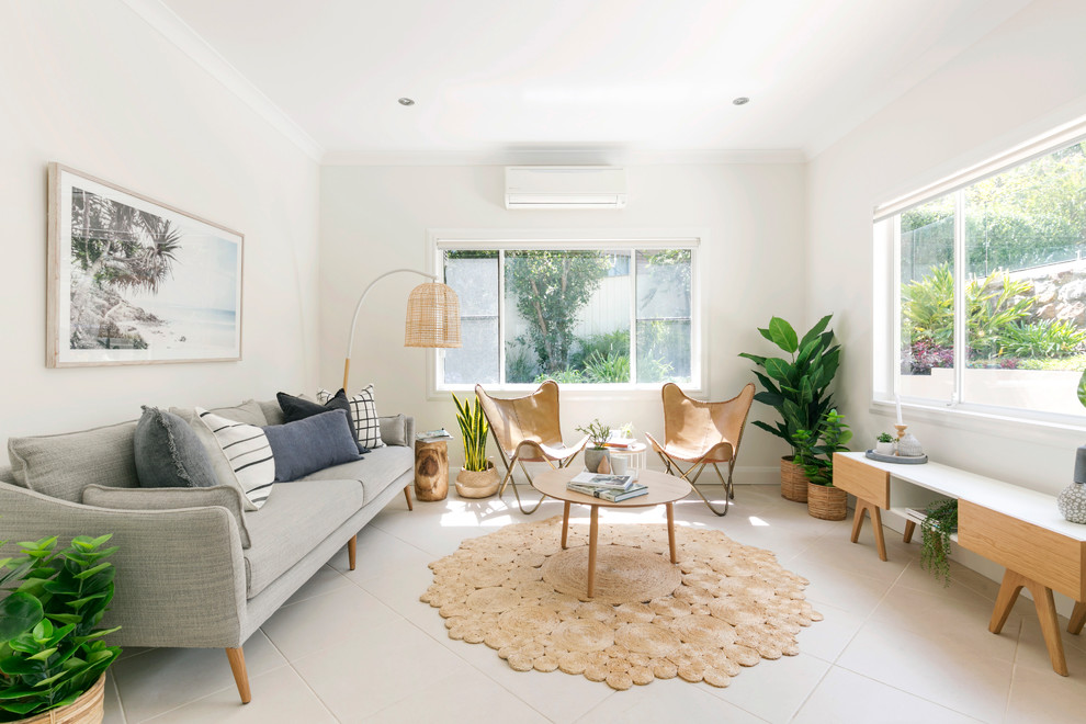 Design ideas for a beach style living room in Sydney with beige walls and beige floor.