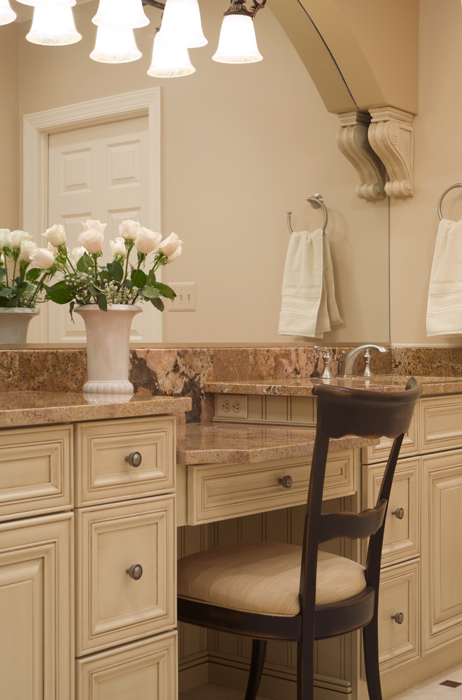 Photo of a traditional bathroom in DC Metro with recessed-panel cabinets and beige cabinets.