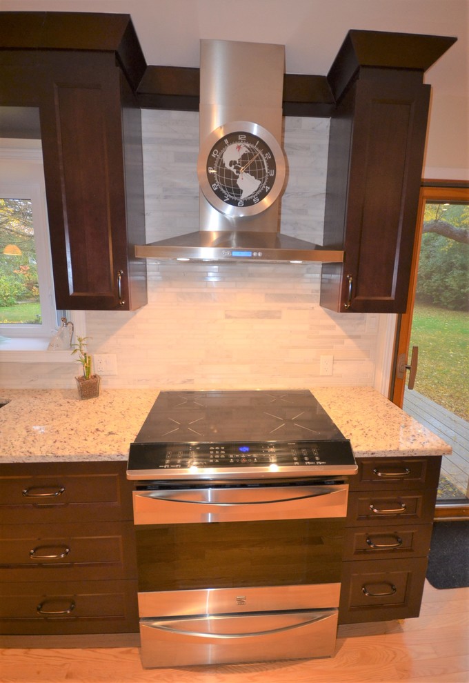 Mid-sized transitional galley medium tone wood floor and brown floor eat-in kitchen photo in Ottawa with recessed-panel cabinets, dark wood cabinets, granite countertops, gray backsplash, stainless steel appliances, a double-bowl sink, porcelain backsplash, a peninsula and beige countertops