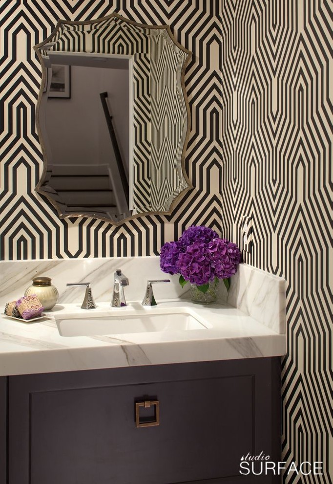 Inspiration for a modern powder room remodel in San Diego with an undermount sink, furniture-like cabinets, gray cabinets, marble countertops and a one-piece toilet