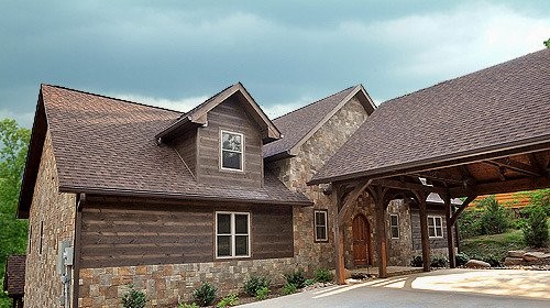 Example of a mountain style three-story exterior home design