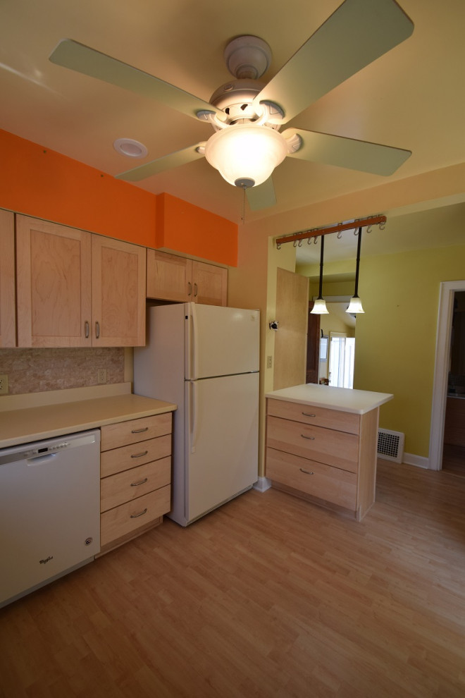 Kitchen - mid-sized transitional u-shaped light wood floor kitchen idea with an integrated sink, shaker cabinets, light wood cabinets, multicolored backsplash, stone tile backsplash, a peninsula and white countertops