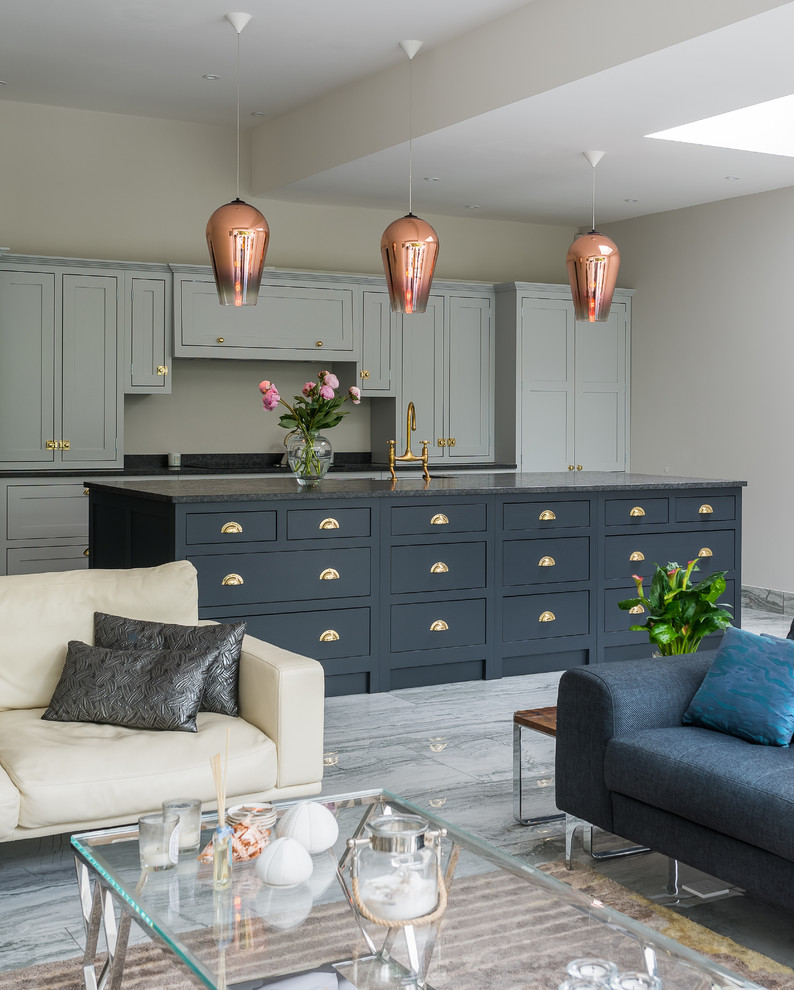 Photo of a large traditional open plan kitchen in London with shaker cabinets, quartz benchtops, marble floors and with island.