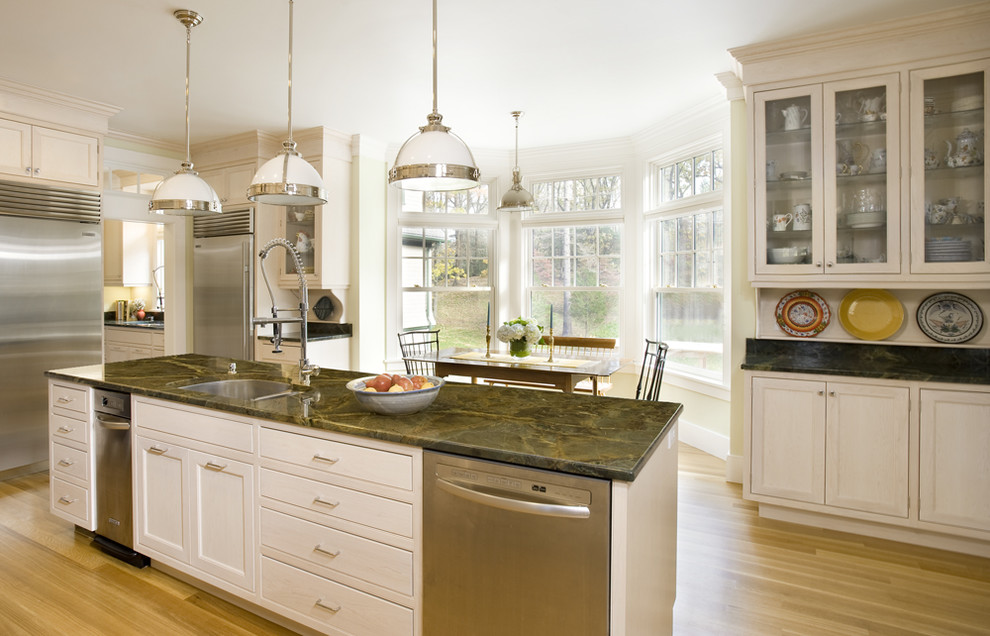 Photo of a traditional kitchen in Boston with glass-front cabinets and stainless steel appliances.