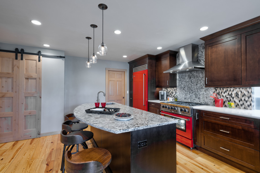 Inspiration for a mid-sized rustic u-shaped light wood floor eat-in kitchen remodel in Seattle with an undermount sink, shaker cabinets, dark wood cabinets, quartz countertops, multicolored backsplash, mosaic tile backsplash, colored appliances, an island and gray countertops