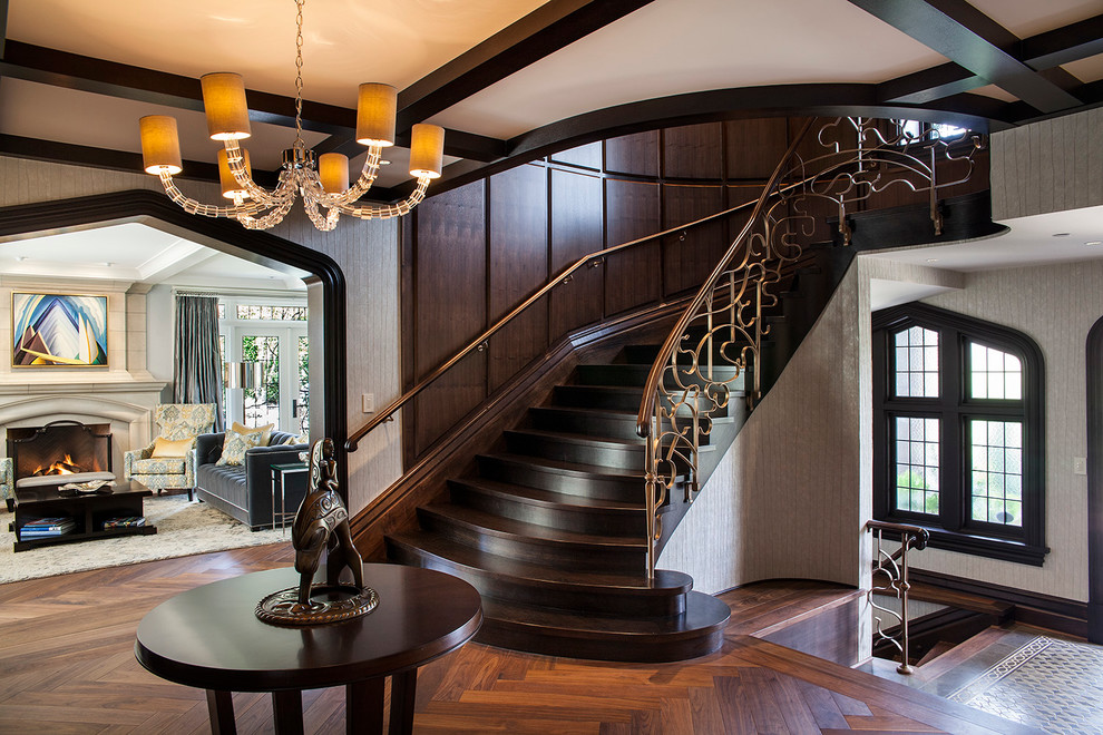 Photo of a transitional wood curved staircase in Vancouver with wood risers.