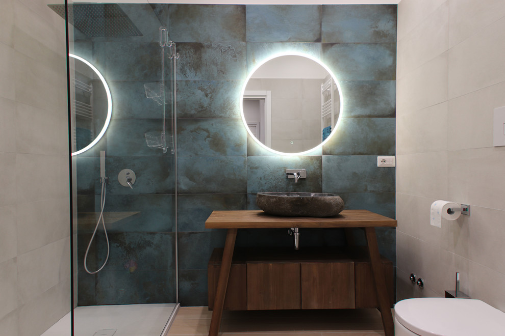 Inspiration for a contemporary 3/4 bathroom in Rome with flat-panel cabinets, medium wood cabinets, an alcove shower, a wall-mount toilet, green tile, light hardwood floors, a vessel sink, wood benchtops, beige floor and brown benchtops.