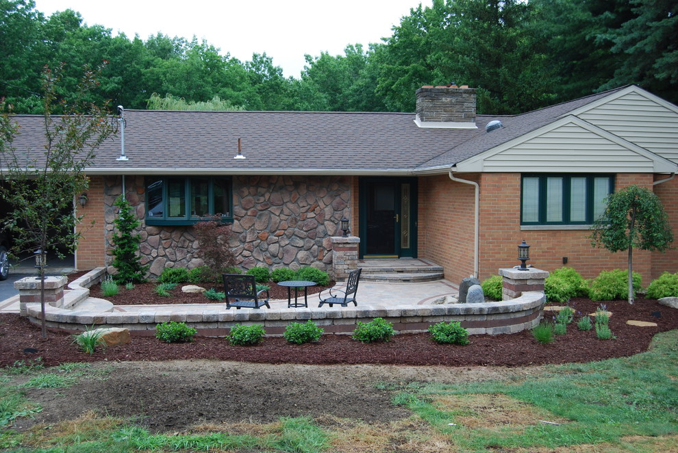 Design ideas for a mid-sized contemporary front yard patio in Other with natural stone pavers.