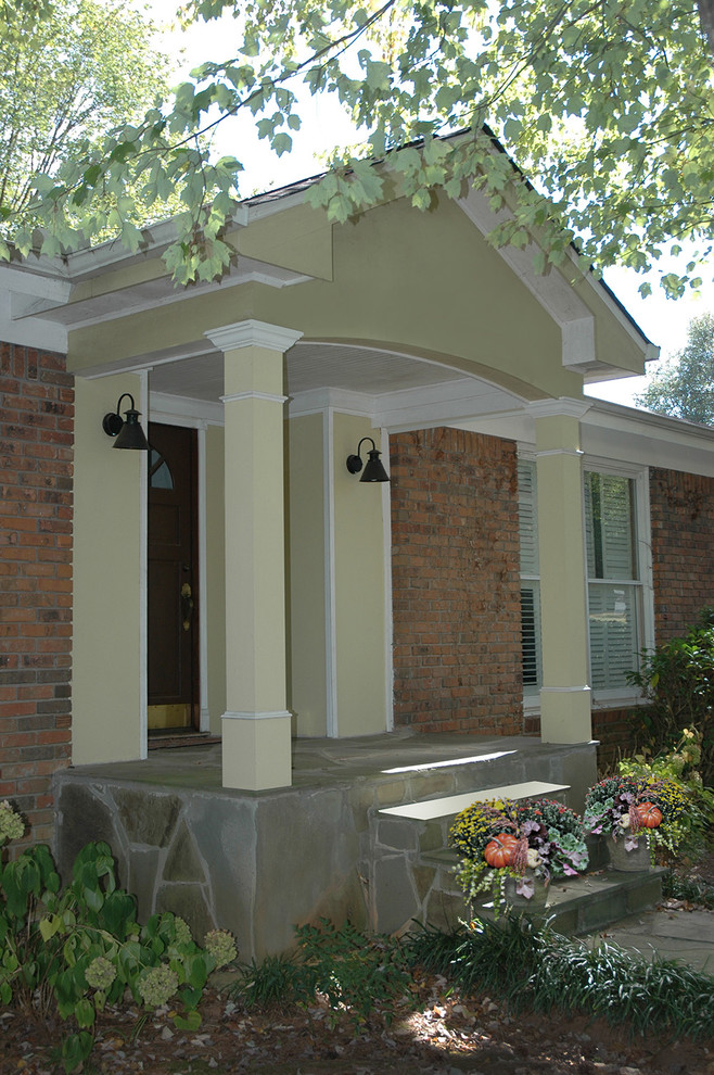 Design ideas for a transitional front yard verandah in Atlanta with a roof extension.