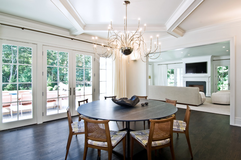 Photo of a transitional dining room in New York with white walls and dark hardwood floors.