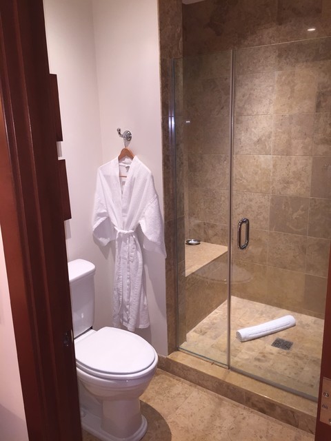 Example of a large classic master beige tile and stone tile pebble tile floor bathroom design in Other with an undermount sink, recessed-panel cabinets, dark wood cabinets, marble countertops, a two-piece toilet and white walls