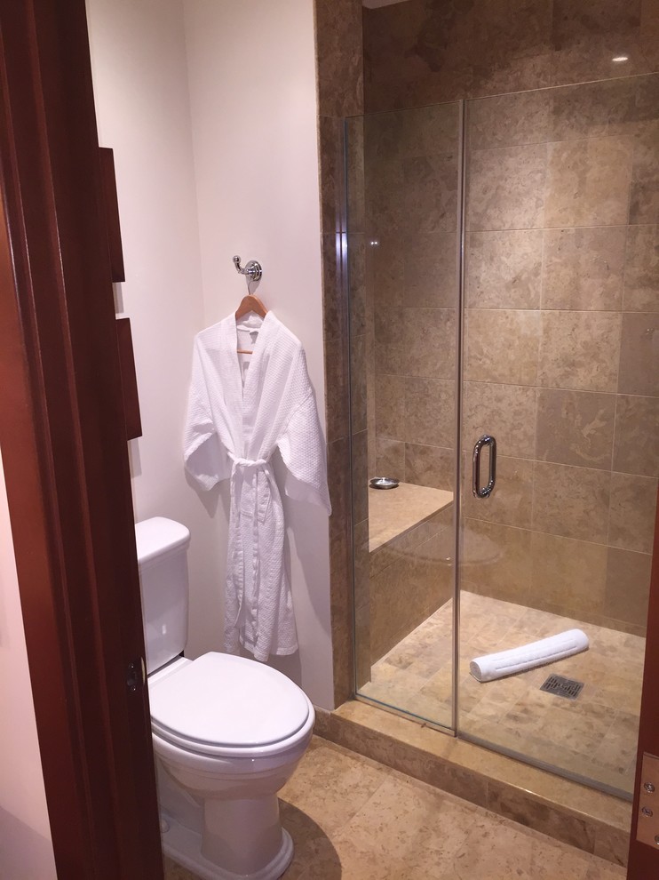 This is an example of a large classic ensuite bathroom in Other with a submerged sink, recessed-panel cabinets, dark wood cabinets, marble worktops, a freestanding bath, a corner shower, a two-piece toilet, beige tiles, stone tiles, white walls and pebble tile flooring.