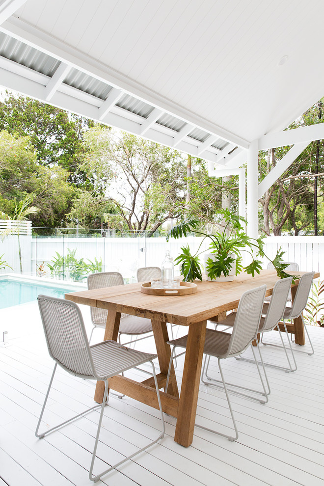 This is an example of a beach style deck in Brisbane with a roof extension.