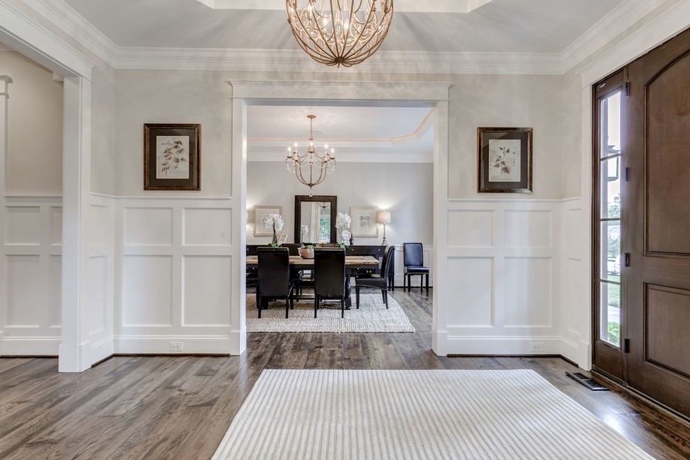 Mid-sized transitional entryway in DC Metro with white walls, plywood floors, a single front door and a dark wood front door.