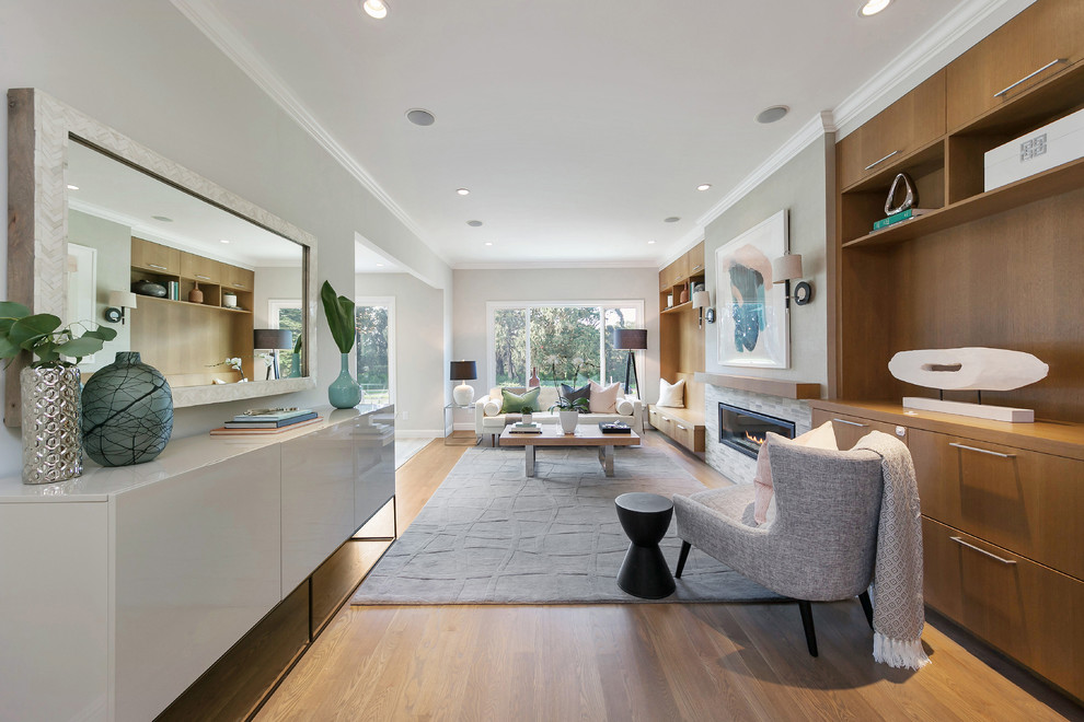 Inspiration for a large transitional formal open concept living room in San Francisco with medium hardwood floors, a standard fireplace, no tv, a tile fireplace surround and grey walls.