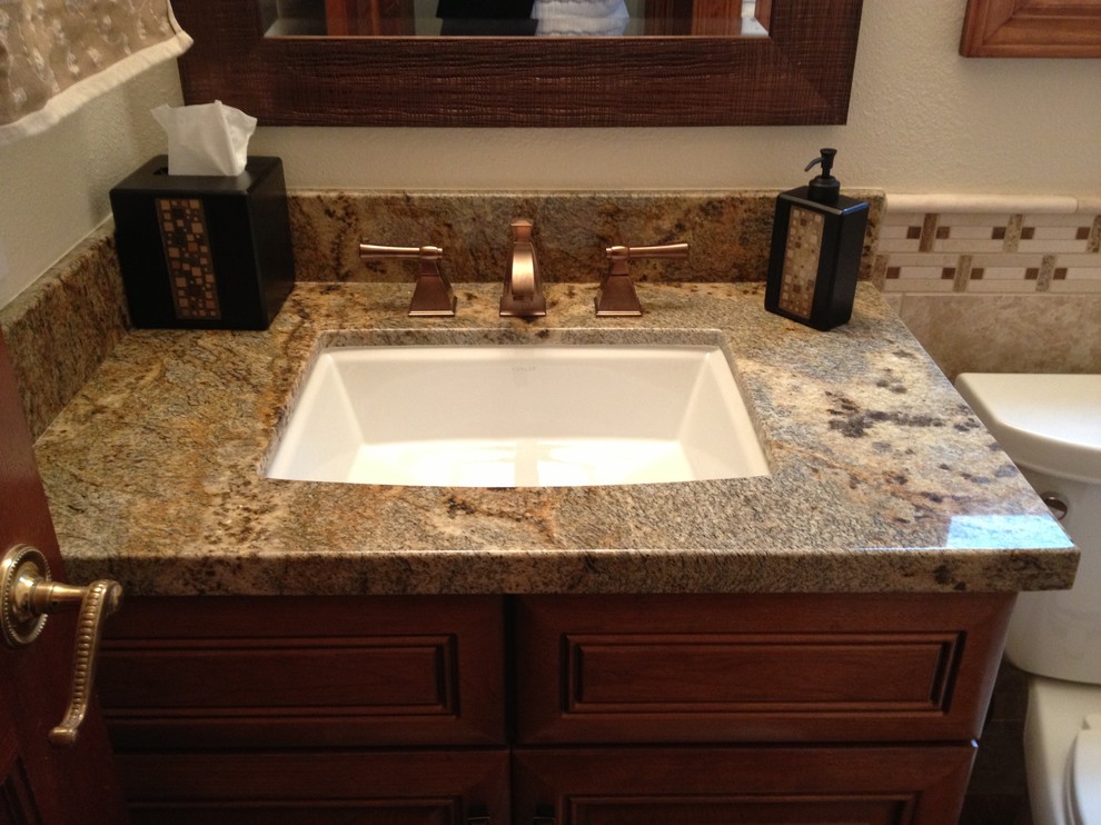 Inspiration for a mid-sized traditional 3/4 bathroom in Orange County with raised-panel cabinets, medium wood cabinets, a corner shower, a two-piece toilet, beige walls, travertine floors, an undermount sink and granite benchtops.