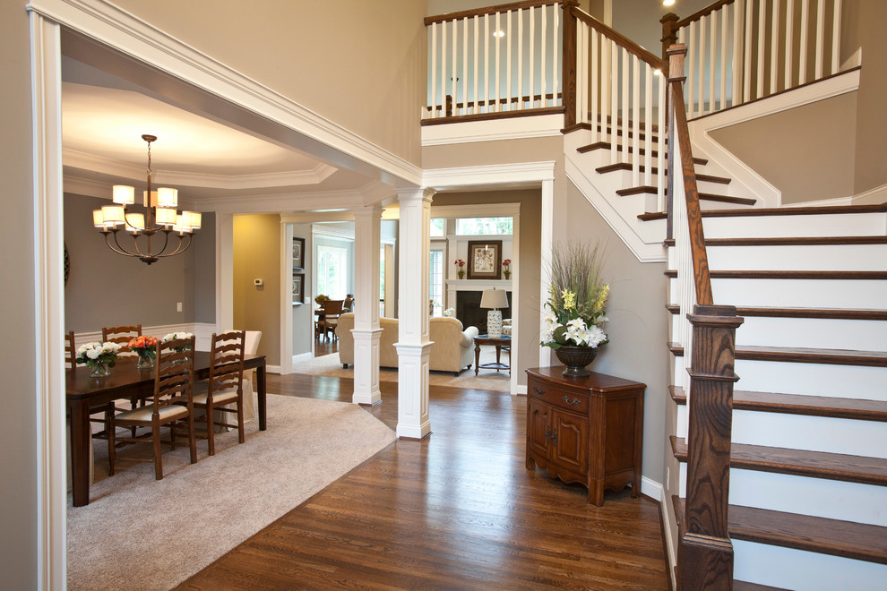 Large transitional dark wood floor foyer photo in Cincinnati with gray walls and a dark wood front door