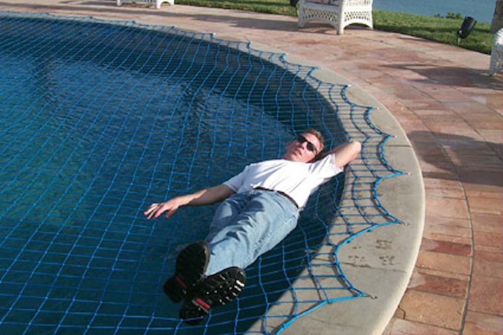 Example of a mid-sized backyard stone and custom-shaped hot tub design in Miami