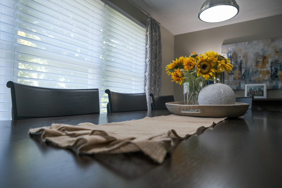 Example of a transitional brown floor dining room design in Grand Rapids with beige walls