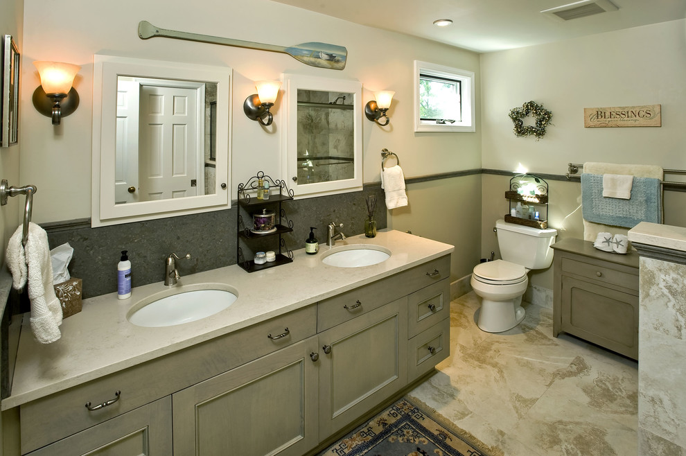 This is an example of a beach style bathroom in Philadelphia with an undermount sink, recessed-panel cabinets, grey cabinets and beige tile.