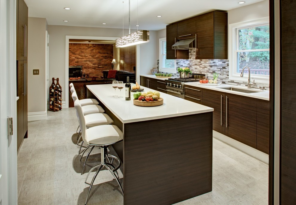 Contemporary separate kitchen in New York with an undermount sink, flat-panel cabinets, dark wood cabinets, mosaic tile splashback and stainless steel appliances.