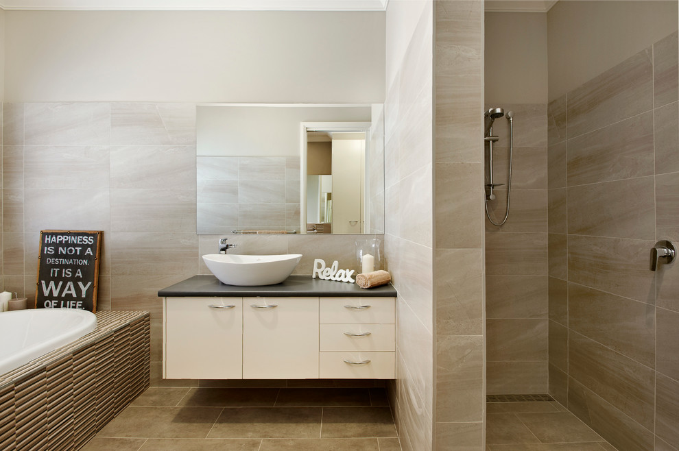 Photo of a mid-sized contemporary kids bathroom in Sydney with a vessel sink, flat-panel cabinets, beige cabinets, engineered quartz benchtops, a drop-in tub, an alcove shower, beige tile, ceramic tile, beige walls and ceramic floors.