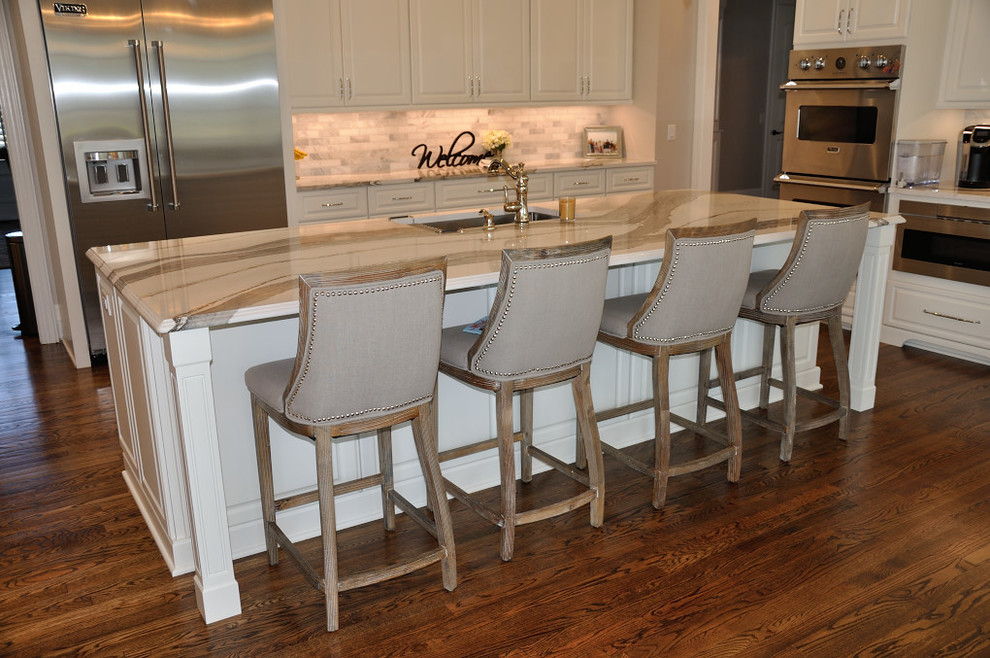 Inspiration for a transitional medium tone wood floor kitchen remodel with an undermount sink, quartz countertops, ceramic backsplash and stainless steel appliances