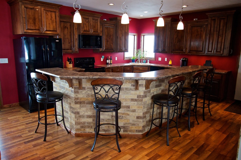 Large open concept kitchen photo with raised-panel cabinets, dark wood cabinets, laminate countertops and an island