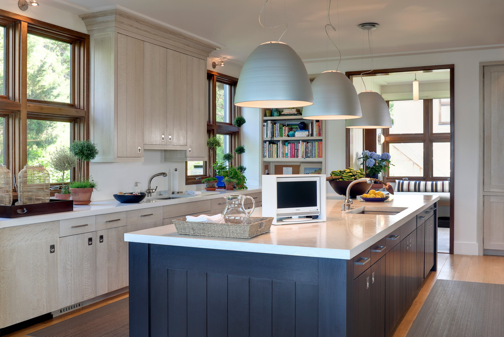 Beach style kitchen in New York with an undermount sink, flat-panel cabinets and blue cabinets.