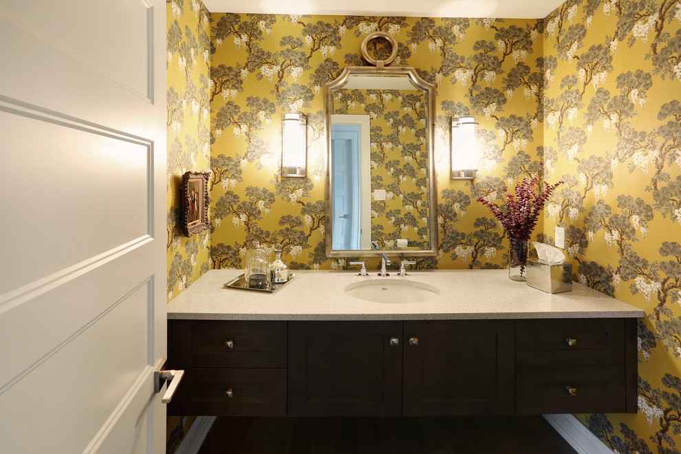 This is an example of a mid-sized midcentury 3/4 bathroom in Toronto with raised-panel cabinets, dark wood cabinets, a one-piece toilet, gray tile, white tile, stone tile, yellow walls, dark hardwood floors, a drop-in sink and soapstone benchtops.