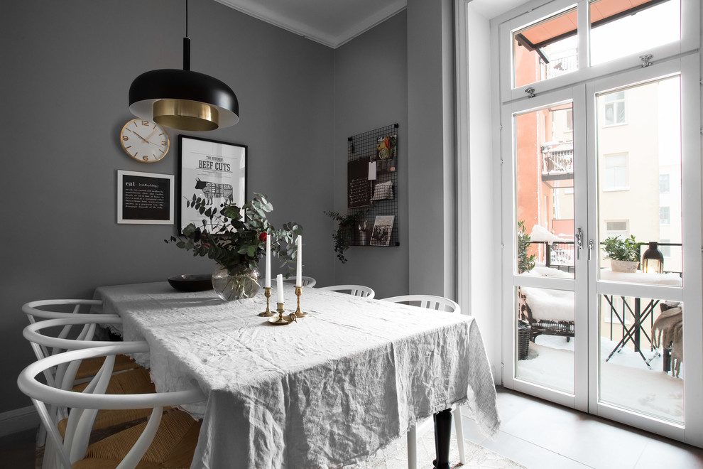 This is an example of a mid-sized scandinavian dining room in Stockholm with grey walls.