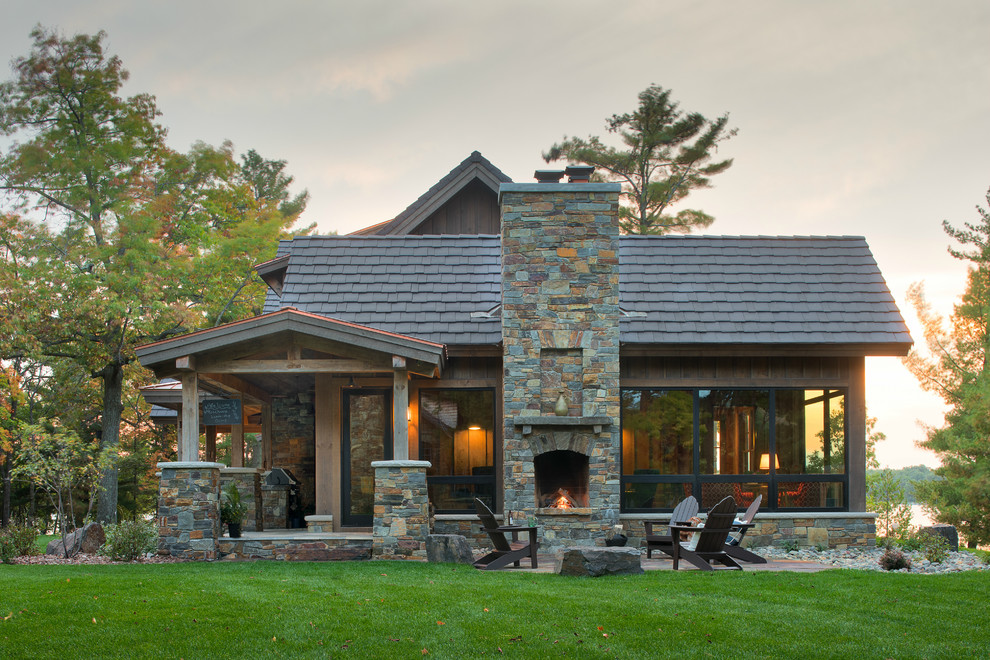 Example of a huge mountain style brown three-story mixed siding gable roof design in Minneapolis with a mixed material roof
