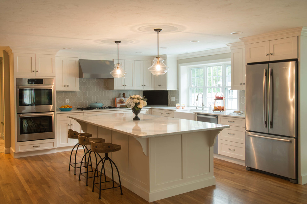 Eat-in kitchen - transitional l-shaped eat-in kitchen idea in Providence with a farmhouse sink, quartzite countertops, ceramic backsplash, stainless steel appliances and an island