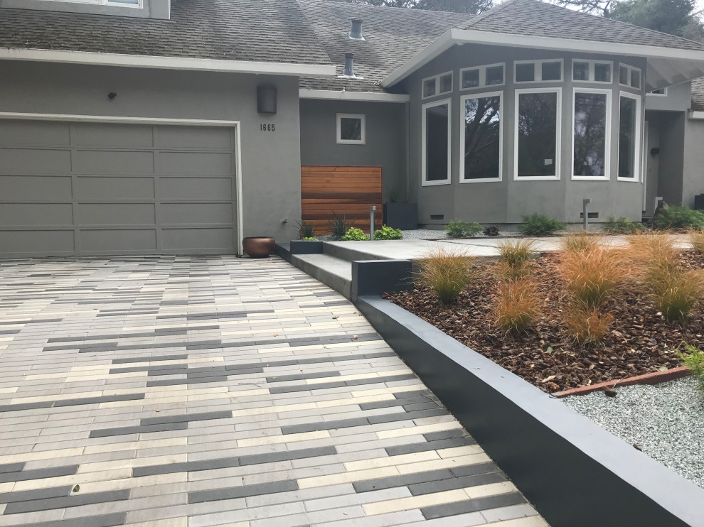Contemporary front yard driveway in San Francisco with with lawn edging and brick pavers.