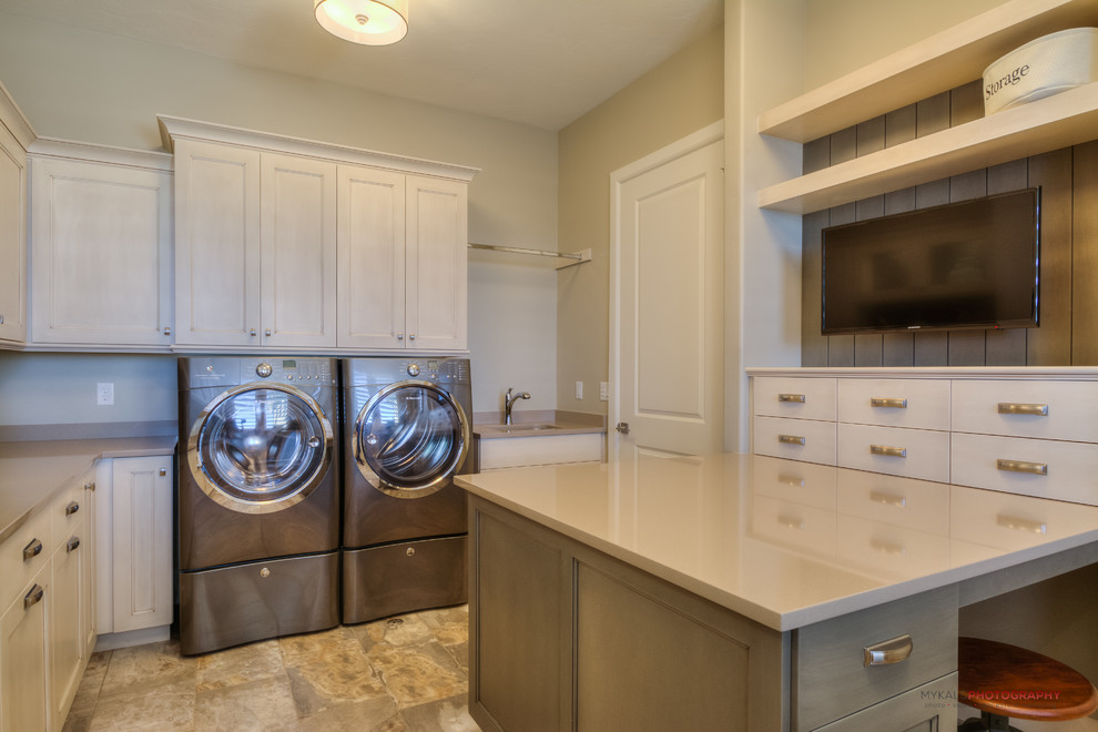 This is an example of a large transitional u-shaped utility room in Salt Lake City with an undermount sink, shaker cabinets, white cabinets, quartzite benchtops, beige walls, porcelain floors and a side-by-side washer and dryer.
