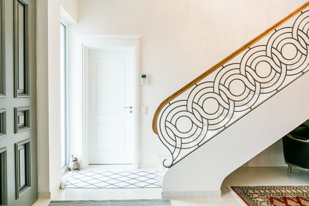 This is an example of a mid-sized asian foyer in Berlin with marble floors, a single front door, white walls, a white front door and beige floor.