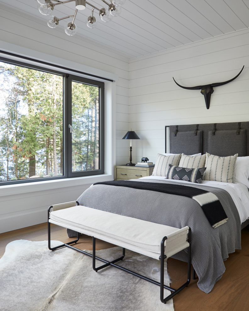 Mid-sized contemporary guest bedroom in Other with white walls, medium hardwood floors, brown floor, timber and planked wall panelling.