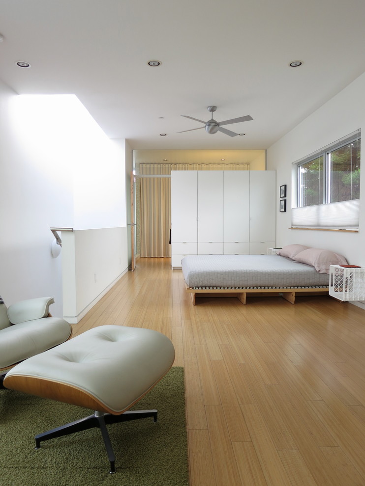 Modern bedroom in Los Angeles with white walls and light hardwood floors.