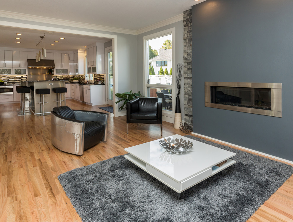 Example of a large trendy u-shaped light wood floor open concept kitchen design with an undermount sink, flat-panel cabinets, white cabinets, granite countertops, multicolored backsplash, mosaic tile backsplash, stainless steel appliances and an island