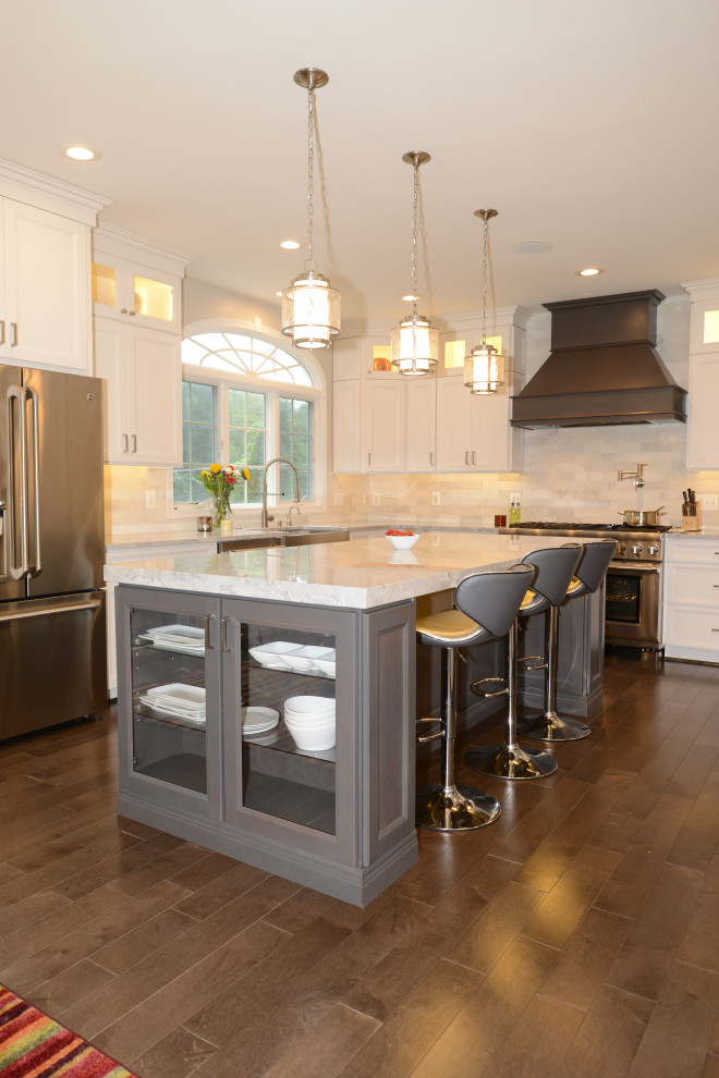 Photo of a mid-sized contemporary eat-in kitchen in DC Metro with beaded inset cabinets, white cabinets, granite benchtops, white splashback, stainless steel appliances, with island, brown floor and white benchtop.