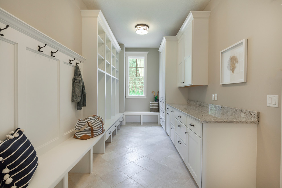 Design ideas for a large traditional mudroom in Minneapolis with white walls, porcelain floors and a pivot front door.