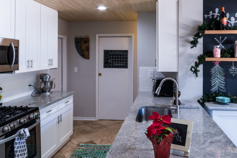 Eat-in kitchen - small transitional cement tile floor and brown floor eat-in kitchen idea with an undermount sink, shaker cabinets, white cabinets, granite countertops, white backsplash, cement tile backsplash, stainless steel appliances, a peninsula and white countertops
