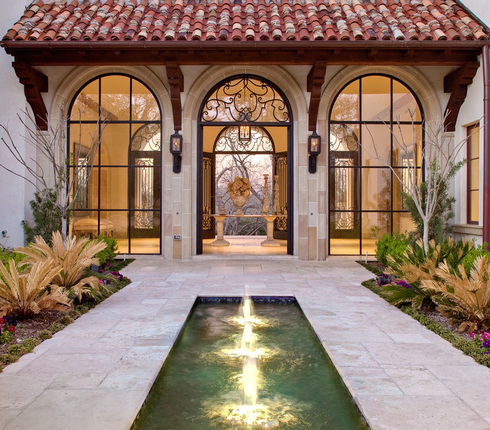 Inspiration for a mediterranean entryway in Dallas with a double front door.