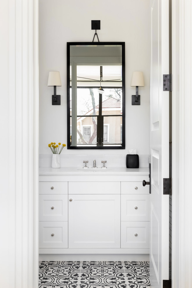Large transitional bathroom in Austin with white cabinets, white walls, ceramic floors, a drop-in sink, multi-coloured floor, a hinged shower door and white benchtops.