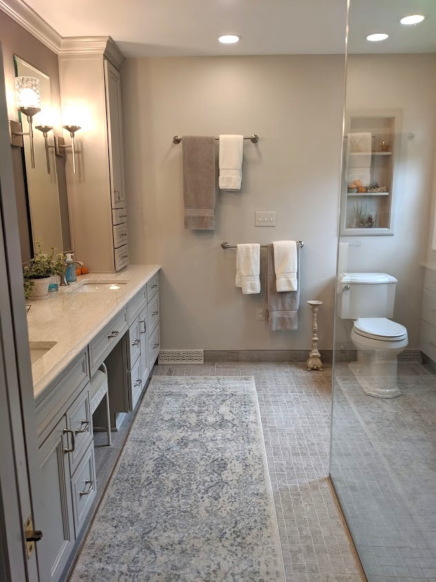 This is an example of a mid-sized traditional master bathroom in Other with beaded inset cabinets, grey cabinets, a curbless shower, a two-piece toilet, gray tile, porcelain tile, grey walls, mosaic tile floors, an undermount sink, engineered quartz benchtops, grey floor, a hinged shower door and white benchtops.
