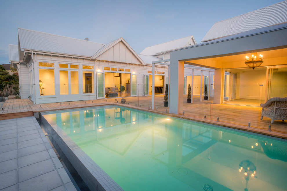 Contemporary backyard pool in Christchurch with decking.