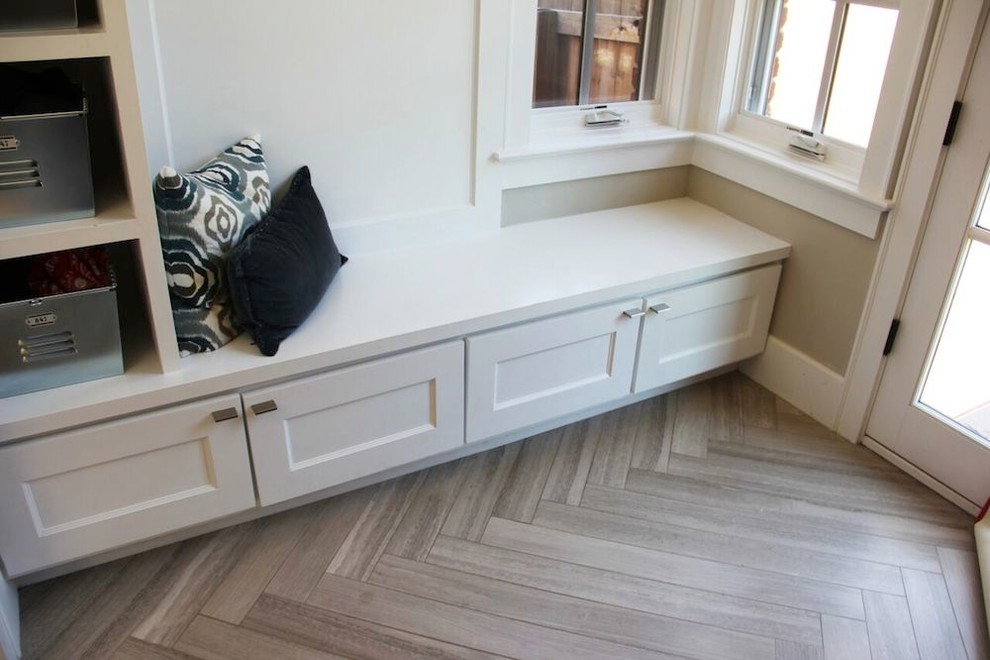 Inspiration for a mid-sized contemporary mudroom in Denver with grey walls and limestone floors.