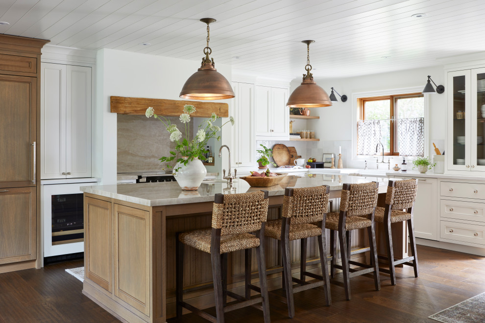 Large transitional l-shaped medium tone wood floor, brown floor and shiplap ceiling open concept kitchen photo with a farmhouse sink, shaker cabinets, light wood cabinets, solid surface countertops, multicolored backsplash, ceramic backsplash, paneled appliances, an island and multicolored countertops